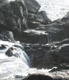 Water flowing back into one of the stone arches