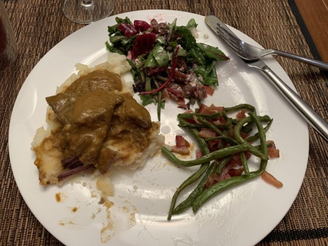 Shorts ribs and gravy over mashed potatoes, green beans with bacon and maple syrup, and beet salad. Partly eaten.